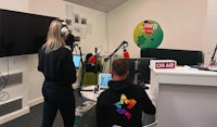 two people in a radio studio with headphones on